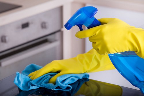 Trained cleaning staff using protective equipment during carpet cleaning