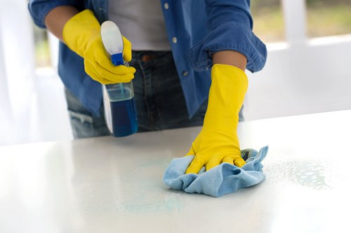 Technician treating high-traffic carpet areas in an Ilford commercial building